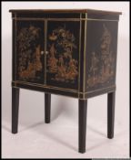 A Chinese aesthetic movement revival side cabinet with chinoserie decoration to the twin cupboard
