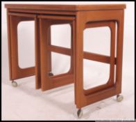 A retro 1970's teak wood Danish style nest of tables. Each table with graduating size top.