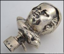 A Victorian silver hallmarked babies rattle of a childs head form with Birmingham assay marks