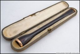 A early 20th century 9ct gold banded tortoise shell cheroot holder, retaining original case.