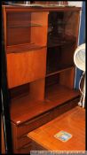 A 1970's retro upright teak wood veneer display cabinet.