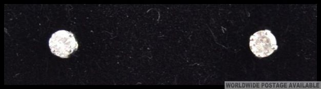 A pair of 14ct w/g diamond studs of 20 points