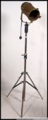 A vintage mid century metal cased theatre lamp being enamel painted gold,