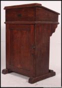 A large 19th century Victorian oak lecturn desk. Of raised form with sloped hinged desk top.