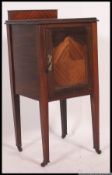 An Edwardian mahogany bedside cabinet / pot cupboard being raised on squared legs with locker door