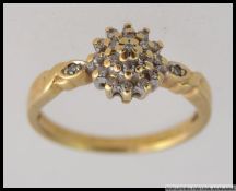An 9ct gold and diamond cluster ring,