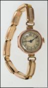 A ladies 9ct / 375 gold vintage dress watch set on rolled gold expanding bracelet. Total weight 16.