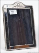 A good silver Adams revival photograph frame (unmarked ) having velvet lined inner with easel back.