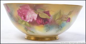 A Royal Worcester Ivory blush fruit bowl being handpainted with floral rose sprays,