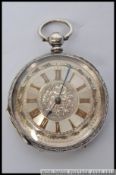 A silver hallmarked ladies decorative fob watch having worked facia gilded roman numerals all in a