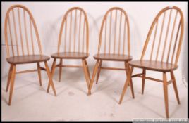 A set of 4 Ercol Quaker pattern beech and elm wood dining chairs.