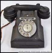 An early 20th century Bakelite telephone having chromium ring dialer with notation exchange plate