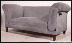 An Edwardian drop end chesterfield sofa settee raised on bun legs with castors having blue velour