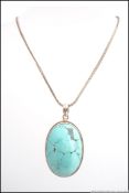 A stunning turquoise ladies bracelet of expanding form together with a turquoise large pendant on