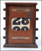 A vintage early 20th century mahogany cased desk top calendar.
