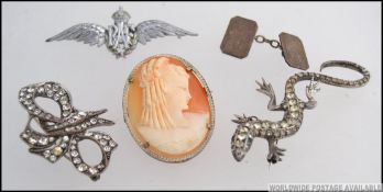 A silver and marcasite ladies silver lizard brooch together with another marcasite bow brooch,