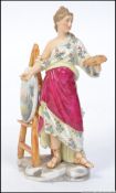 A 19th century Meissen type figurine of a female artist at an easel painting a country scene.