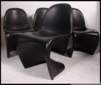A set of 20th century contemporary 4 Verner Panton ' S ' Chairs in black plastic construction.