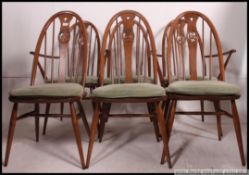 A set of 6 Ercol Golden Dawn beech and elm wood swan back quaker dining chairs.
