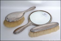 A silver hallmarked dressing table set to include hand mirror,