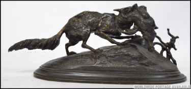 A contemporary 20th cenutry hollow cast bronze sculpture of a wolf with pheasant signed to the