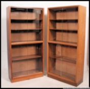 A pair of mahogany sliding glass double library bookcase cabinets.
