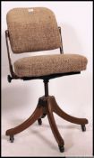 A retro 1950's Industrial office swivel chair with metal quadruped base having wool upholstered