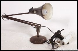 A retro 1970's Herbert Terry anglepoise lamp with a circular base along with a inspection / work