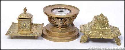 A good antique regency brass inkwell mounted with caryatids, along with two other brass inkwells.