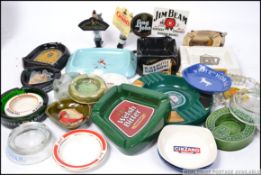 A collection of assorted vintage breweriana related collectables to include ashtrays,