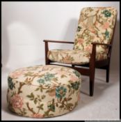 A vintage mid century Danish influence teak open frame lounge armchair together with the ottoman