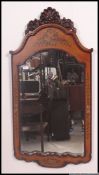 A good quality Victorian style mahogany wall mirror of rococo form with stencil decorated top.
