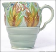 A Clarice Cliff large water jug with moulded leaf and berry foliate to body. Stamped to base 41a.