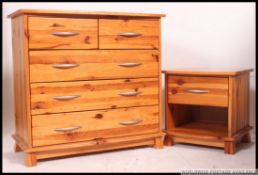 A contemporary pine two over three chest of drawers along with a matching bedside cabinet.