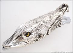 A large silver plated clip in the shape of a pikes head.