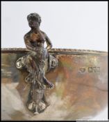 A silver hallmarked twin handled rose bowl having stunning twin handles of a maiden and a faun