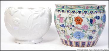 A large Chinese ceramic planter highly decorated with colourful panels along with a similar sized