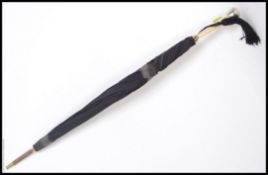 A Victorian silver and bone inlaid gentlemans umbrella being re-lined.