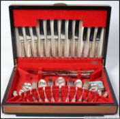 A 20th century mahogany cased canteen of cutlery complete with contents, the case being baize lined.