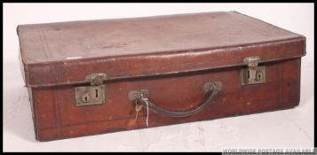 An early 20th century large high quality solid leather suitcase complete with the leather handle
