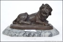 A 20th century bronze cast of a recumbent roaring lion,