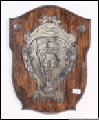 A retro vintage 1950's Dr Barnardo's plaque of white metal construction set to a wooden armorial