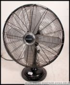 A decorative vintage looking heavy cast metal painted black desk fan,