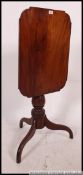 A 19th century Georgian mahogany tilt top tripod wine table.