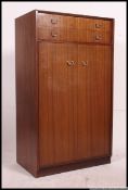 A 1960's Ernest Gomme for G-Plan tola wood tallboy chest of drawers cabinet.