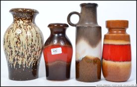 A collection of four West German pottery vases, each in usual colouring, with makers marks to base.