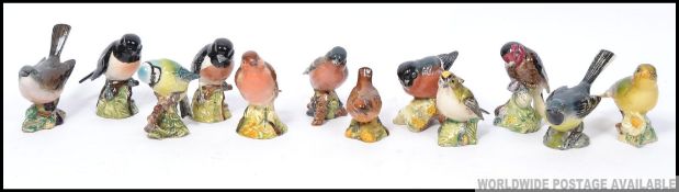 A collection of 12 Beswick birds to include stone chat , white throat , blue tit , chaffinch ,