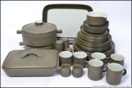 A good quality retro 1970's Denby stoneware dinner service in green with dinner plates, side plates,