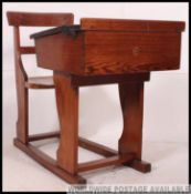 A Victorian oak and elm wood school desk and chair being integrated on sleigh runners,