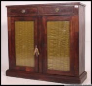 A 19th century Regency rosewood pier cabinet being raised on a plinth base with twin glazed doors